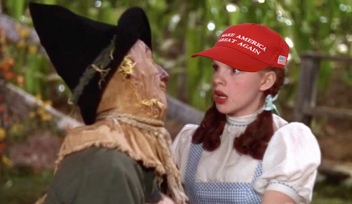 Dorothy Gale of Kansas, wearing a red MAGA cap is surprised by the Scarecrow’s admission that he has no brain